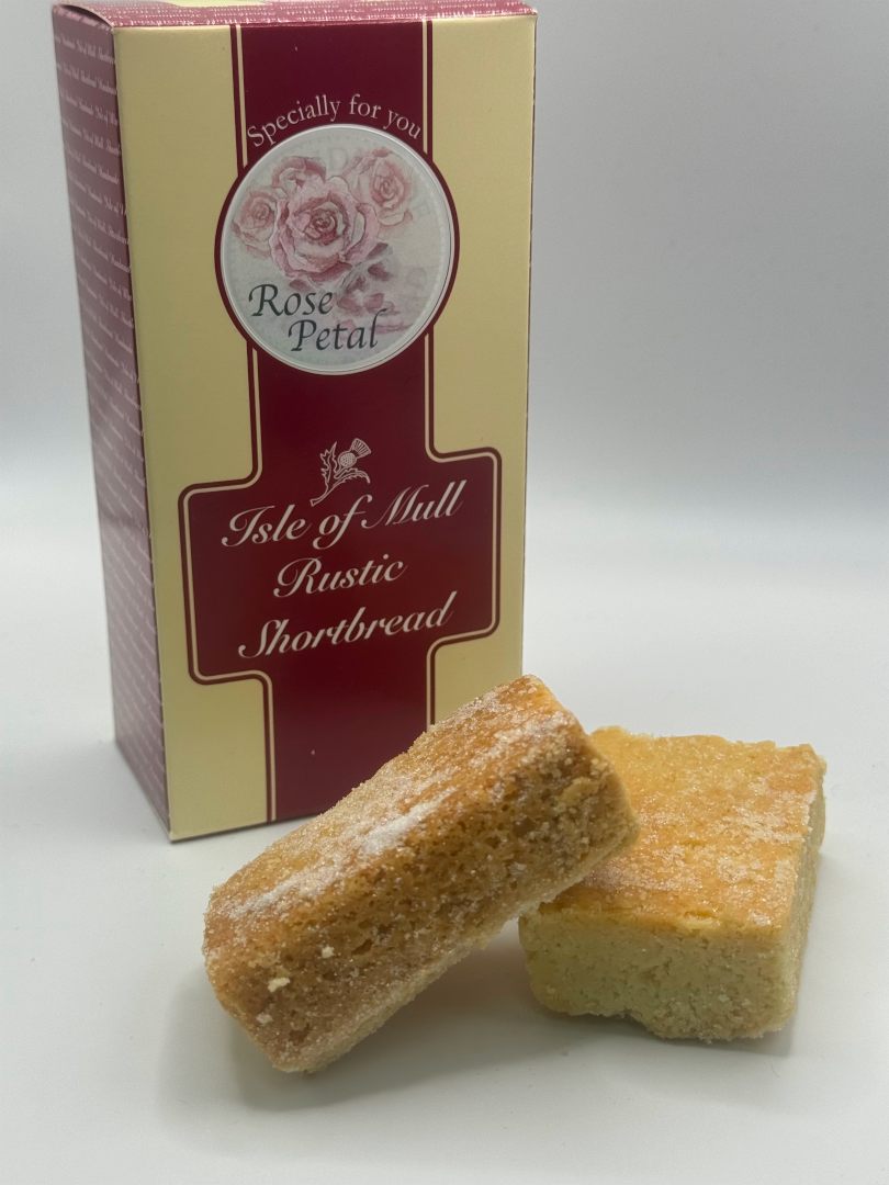 box of tobermory stores handmade rose petal shortbread with two delicious pieces of tobermory stores rose petal handmade shortbread in the foreground