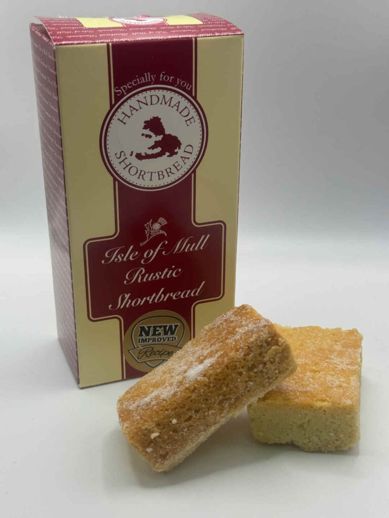 box of tobermory stores handmade rustic shortbread with two delicious pieces of tobermory stores rustic handmade shortbread in the foreground